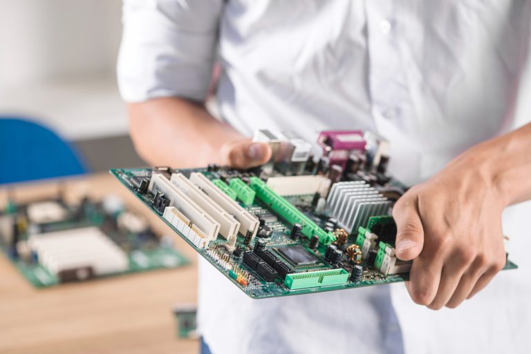 close-up-male-technician-holding-computer-motherboard1