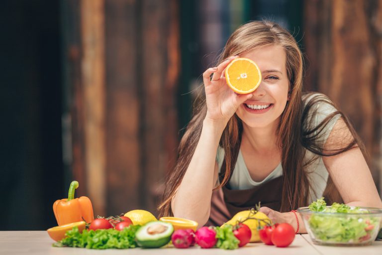 Happy young girl with an orange